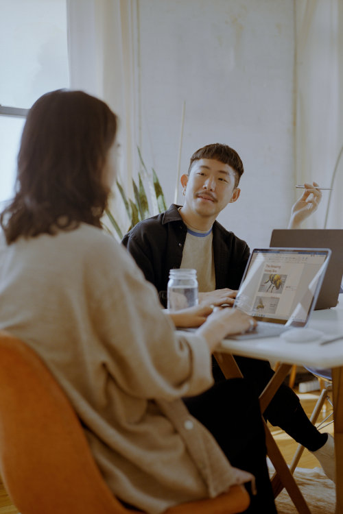 Man and woman talking at a table.